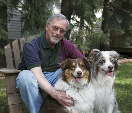 Dr. John Pharr with his two Australian shepherds, Booster (left) and Brodie. Photo: Myrna MacDonald.