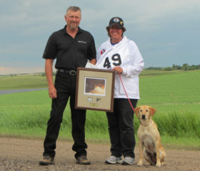 Dr. Sue Taylor and Candy accept their finalist trophy from Bill Kennedy, president of the National Retriever Club of Canada. Photo courtesy of Dr. Sue Taylor.